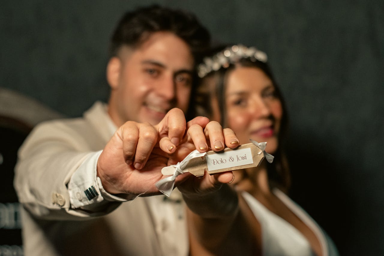 A joyful bride and groom hold their wedding favors, celebrating love and unity on their special day.